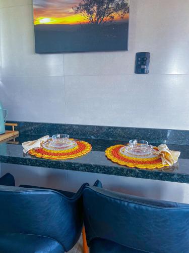two dishes sitting on a counter in a restaurant at Chalé Heinz in Rancho Queimado
