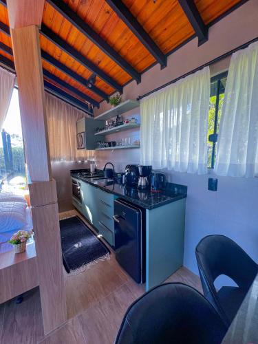 a kitchen with a stove and a counter top at Chalé Heinz in Rancho Queimado
