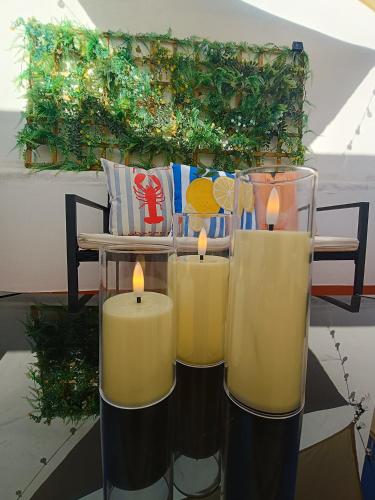 three candles sitting on top of a table at Casa Aguadulce Puerto in Aguadulce