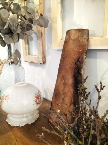 a piece of wood sitting on a table next to a vase at Casa Solar do Tristão in Santa Maria Madalena