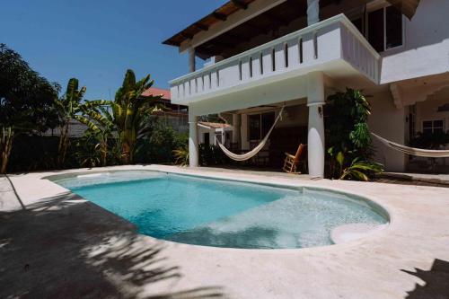 a swimming pool in front of a house at Casa del Alma in Puerto Escondido