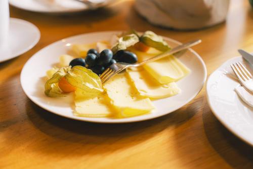 a plate of food with fruit on a table at Heiterwanger Hof Appartments in Heiterwang