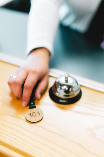 a person is reaching for a button on a table at Heiterwanger Hof Appartments in Heiterwang