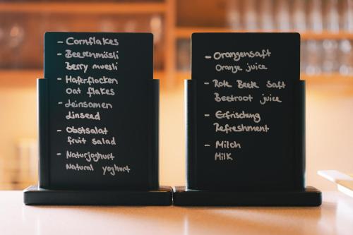 a black menu board with white writing on it at Heiterwanger Hof Appartments in Heiterwang