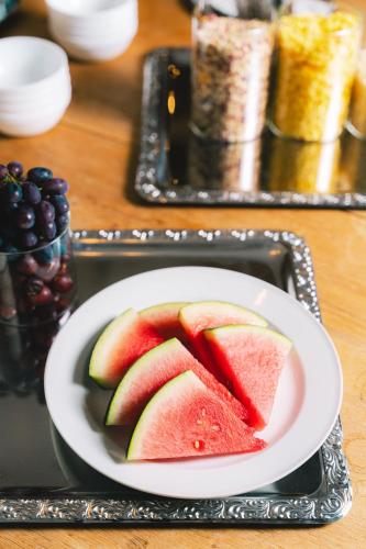 a plate with slices of watermelon on a tray at Heiterwanger Hof Appartments in Heiterwang