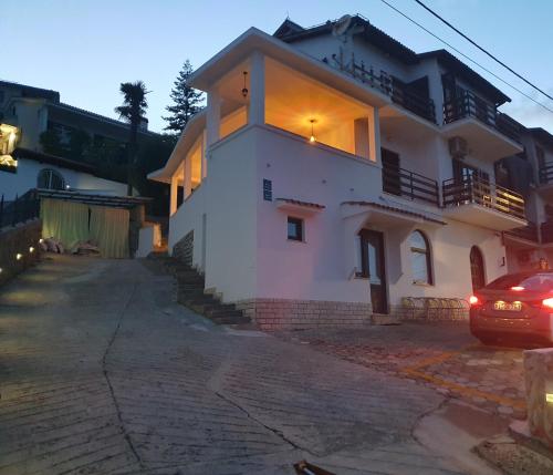 a house with a car parked in front of it at Apartments Opatija Sea View in Opatija