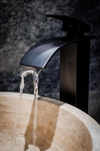 a fountain with water coming out of it at D&D Bucovina in Câmpulung Moldovenesc