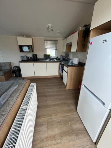 a kitchen with a white refrigerator in a room at 2 Bedroom Caravan 6 Birth The Wolds Ingoldmells Skegness - No pets free WiFi in Ingoldmells