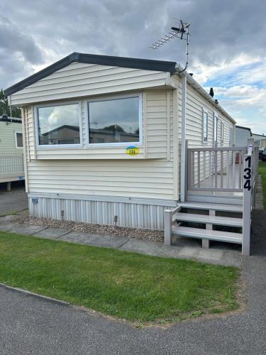 a house with a large window on the side of it at 2 Bedroom Caravan 6 Birth The Wolds Ingoldmells Skegness - No pets free WiFi in Ingoldmells