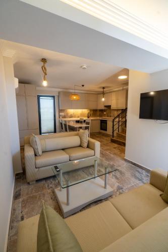 a living room with two couches and a table at Uliv Apart Hotel & SPA in Ayvalık