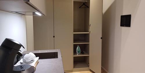 a kitchen with a stove top oven next to a cabinet at Luise LuXe Suites in Tallinn