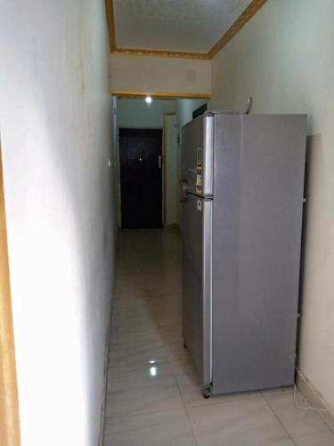 a silver refrigerator in a room with a hallway at Giza Pyramids Hotel in Cairo