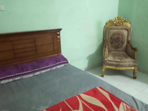 a bedroom with a bed with a chair and a bed sidx sidx at Giza Pyramids Hotel in Cairo