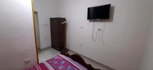 a living room with a tv on a wall at Giza Pyramids Hotel in Cairo