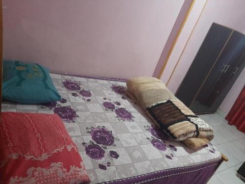 a bed with a quilt on it in a room at Giza Pyramids Hotel in Cairo