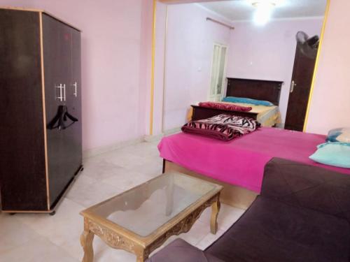 a living room with two beds and a coffee table at Giza Pyramids Hotel in Cairo