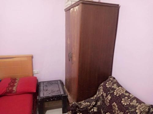 a room with a cabinet and a couch and a chair at Giza Pyramids Hotel in Cairo