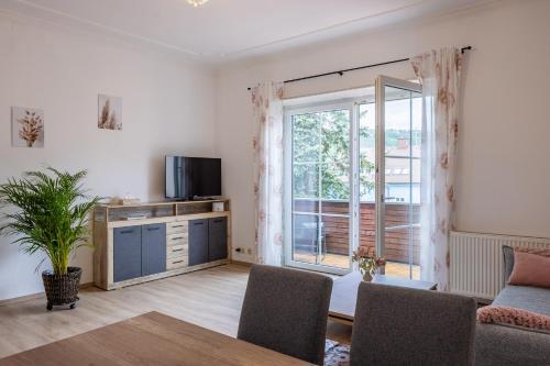 a living room with a tv and a large window at Steinmetz-Haus in Mariazell