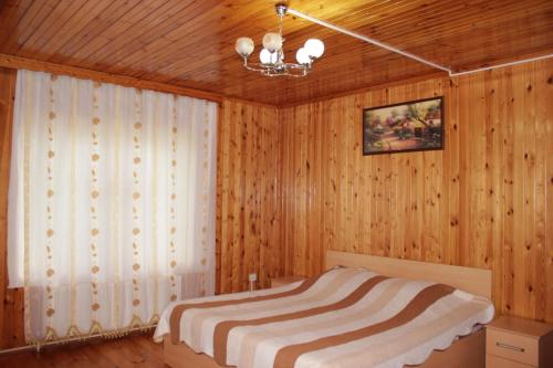 a bedroom with wooden walls and a bed in a room at Qala Masalli Resort in Masallı