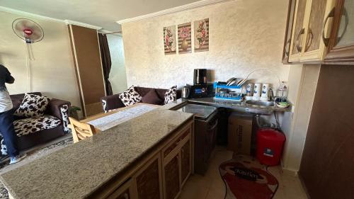 a small kitchen with a couch and a counter top at 3 Bedroom Chalet at Dimora Village North Coast Egy - الساحل الشمالي - قرية ديمورا - شاليه 3 غرف in Dawwār Muḩammad Abū Shunaynah