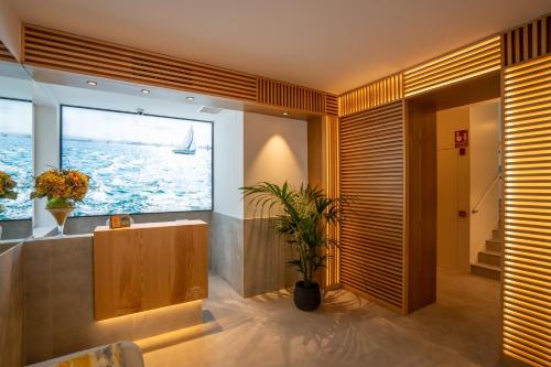 a bathroom with a large window with a boat in the water at Sercotel El Balcón de la Bahía Suites in Santander