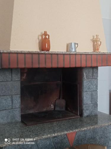 a brick fireplace with a pot on top of it at Casa di Angela in Sannicola