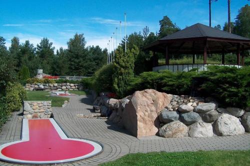 a red yoga mat in a garden with rocks at Charming Cottage near Beach & Nature in Sarpsborg