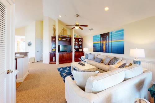 a living room with white furniture and a couch at Sea Nine #C9SC-H in Hatteras