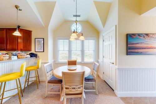 a kitchen and dining room with a table and chairs at Sea Nine #C9SC-H in Hatteras