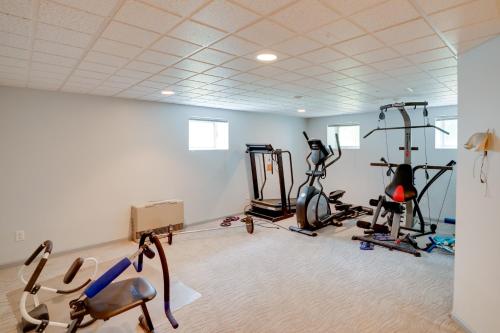 a gym with several exercise bikes in a room at Pool Table and Deck Luxury Mansion in Niskayuna! in Niskayuna