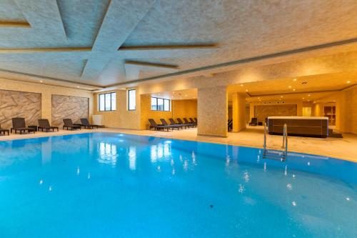 a large swimming pool in a hotel room at Boréa Apartments in Zlatibor