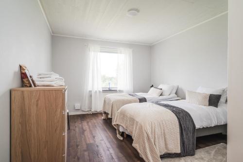 a bedroom with two beds and a window at Newly furnished apartment in Hede near Avesta in Horndal
