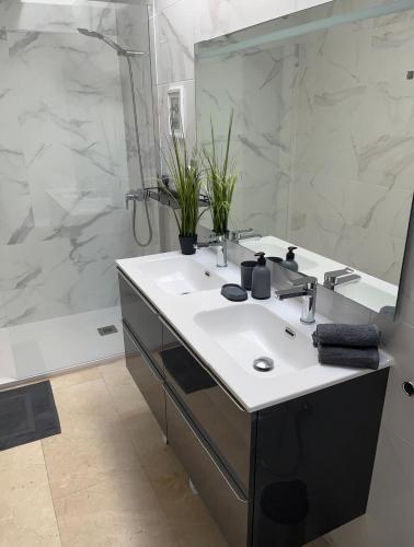 a bathroom with a sink and a large mirror at Villa de los Osos - 3min Walk To The Beach & Club De Golf Playa Serena, Entire House, Chalet With XXL Private Pool & Gym in Roquetas de Mar