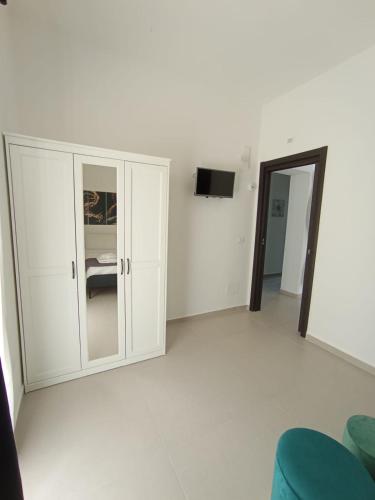 a room with a white cabinet and a television at Villa Nunzia in Ostuni