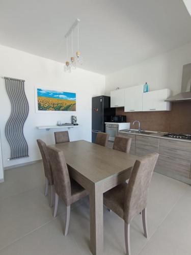 a kitchen with a wooden table and chairs at Villa Nunzia in Ostuni
