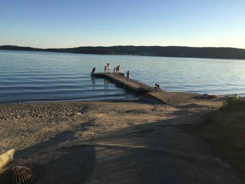 a group of people standing on a dock in the water at Charming Cottage near Beach & Nature in Sarpsborg