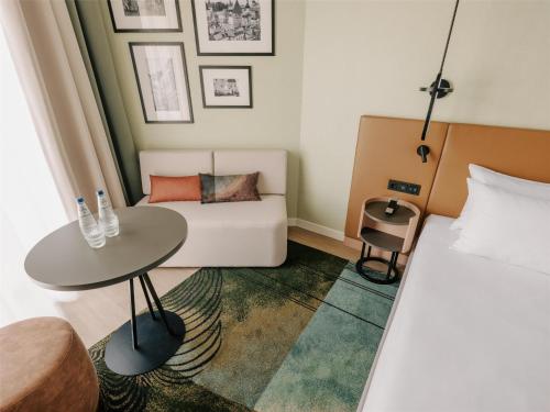 a hotel room with a bed and a table at Hyatt Place Tallinn in Tallinn