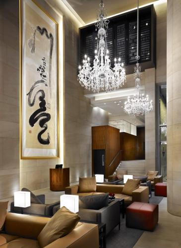 a hotel lobby with couches and chandeliers at Hyatt Vancouver Downtown Alberni in Vancouver