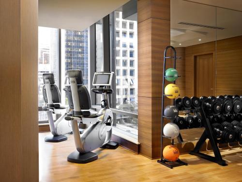 a gym with exercise equipment and a large window at Hyatt Vancouver Downtown Alberni in Vancouver