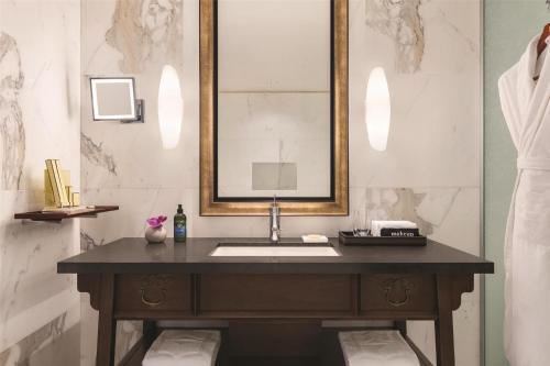 a bathroom with a sink and a mirror at Hyatt Vancouver Downtown Alberni in Vancouver