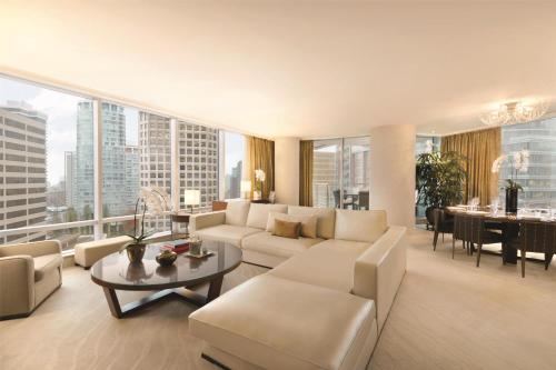 a living room with a couch and a table at Hyatt Vancouver Downtown Alberni in Vancouver