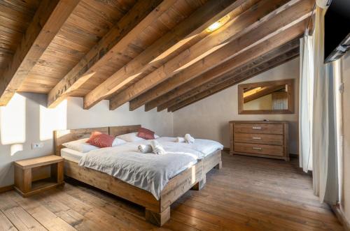 a bedroom with a large bed and a wooden ceiling at Villa Nocciola with Sea View, Private Pool and Sauna in Premantura
