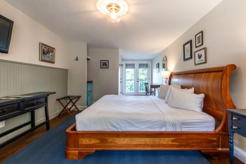 a bedroom with a large bed and a television at The Shire Woodstock in Woodstock