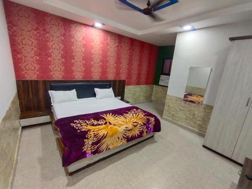 a bedroom with a bed with a painting of a lion at TRPOTELS Shree Ji in Gwalior