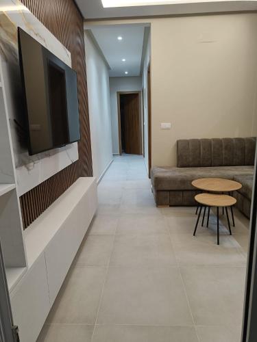a living room with a couch and a tv on a wall at Luxury Mirador 3 Cappuccino in Cabo Negro