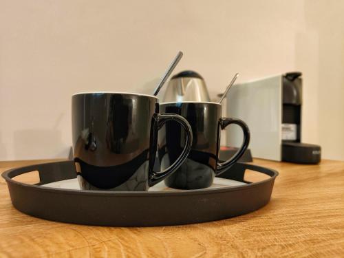 two coffee mugs on a tray on a table at CORFU TENNIS Studios in Agios Rokkos