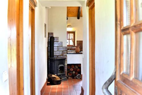 a hallway of a house with a stove in a room at Cerro Da Fontinha in São Teotónio