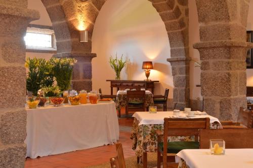 a dining room with two tables in a building at Pousada Mosteiro de Guimaraes in Guimarães
