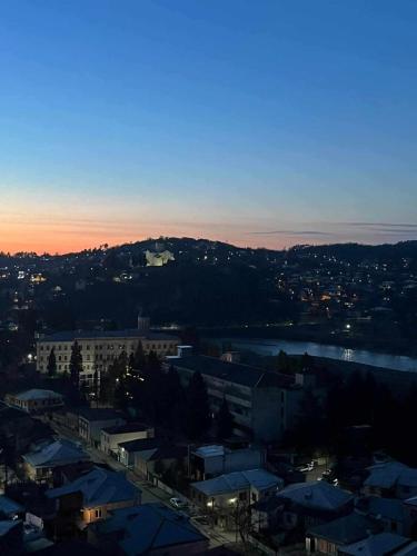 a view of a city at sunset with a city at Gelati Loft Apartment in Kutaisi