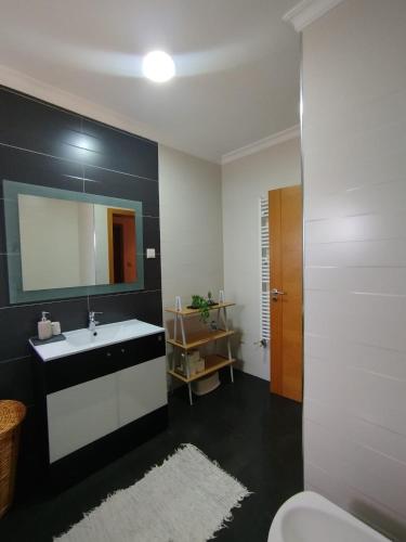 a bathroom with a sink and a mirror and a toilet at Douro & Sabor Escape in Torre de Moncorvo